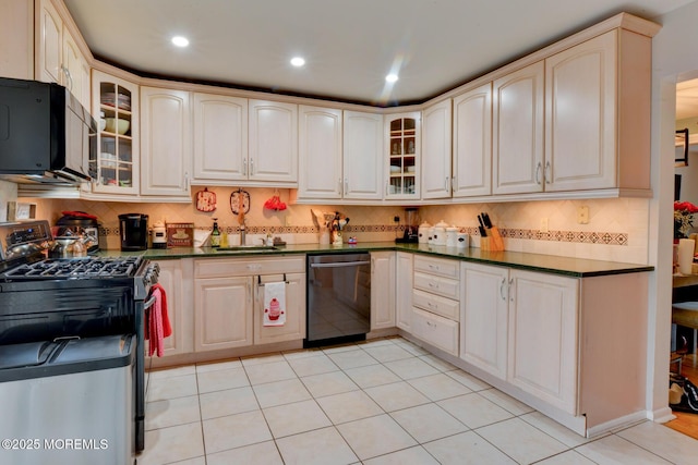 kitchen with stainless steel appliances, light tile patterned flooring, sink, and decorative backsplash