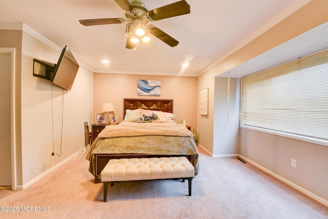 carpeted bedroom featuring crown molding and ceiling fan