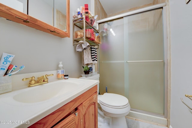 bathroom featuring walk in shower, vanity, and toilet