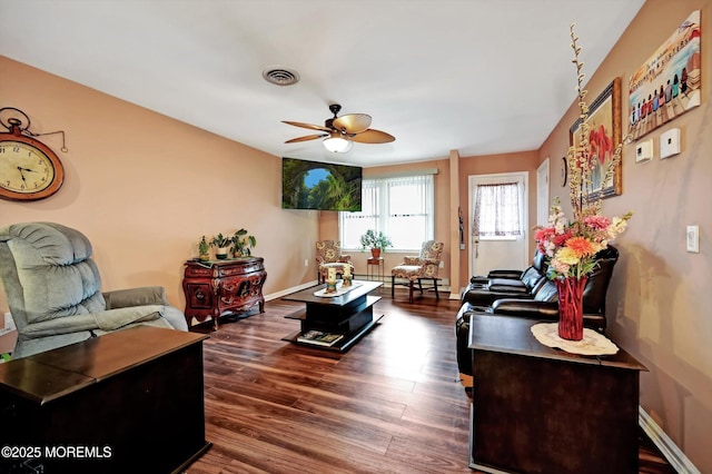 living room with ceiling fan and dark hardwood / wood-style flooring