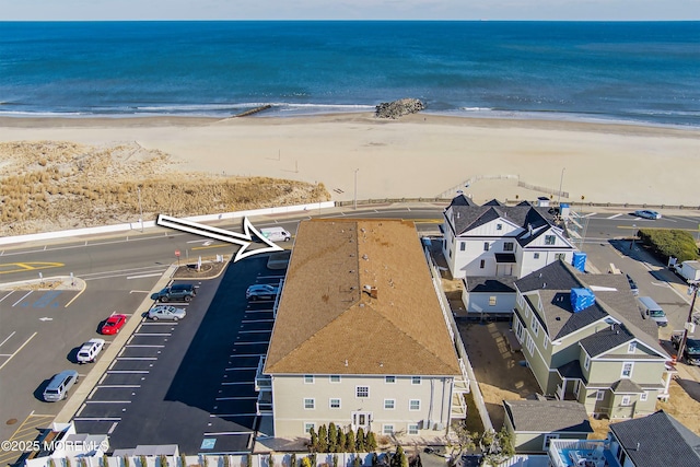 aerial view with a water view and a view of the beach