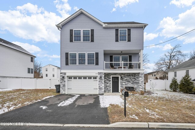 view of front property with a garage and a balcony