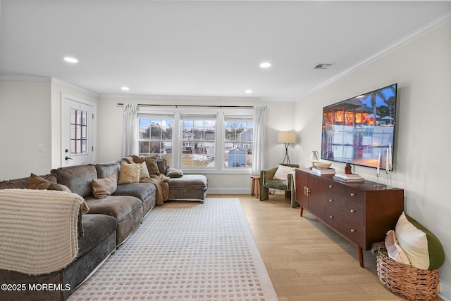 living room with crown molding and light hardwood / wood-style flooring