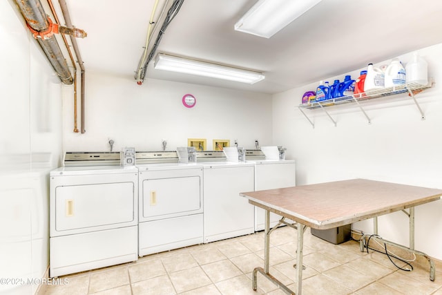 community laundry room featuring light tile patterned floors and separate washer and dryer