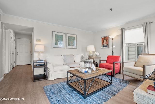 living room featuring ornamental molding, wood finished floors, and baseboards