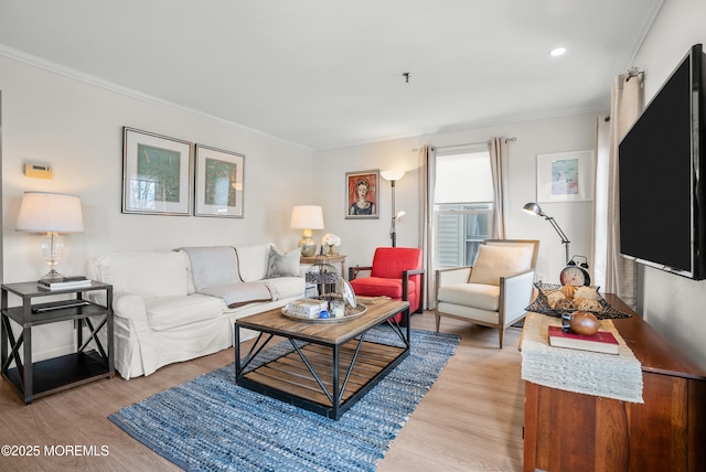 living area featuring ornamental molding, light wood-type flooring, and recessed lighting