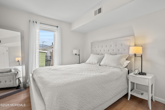 bedroom with baseboards, access to outside, visible vents, and dark wood-style flooring