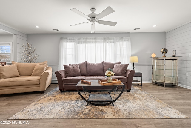 living area featuring visible vents, a ceiling fan, wood finished floors, recessed lighting, and baseboard heating