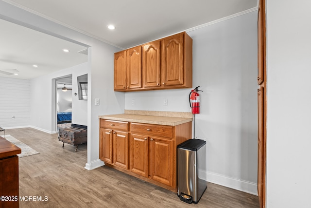 kitchen with light countertops, light wood-style flooring, recessed lighting, and baseboards