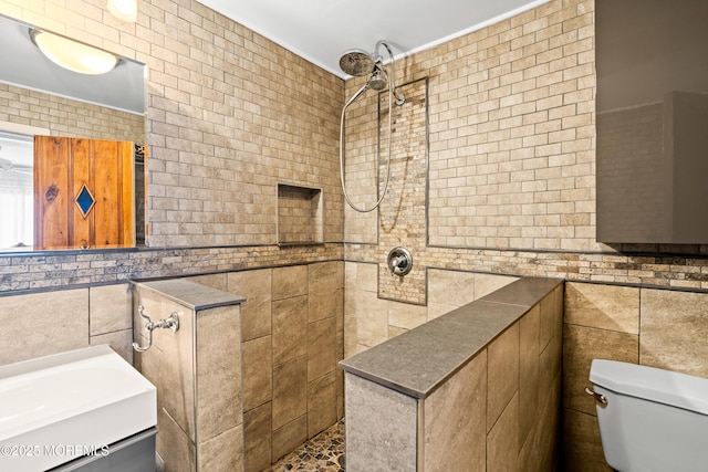 full bathroom featuring tile walls, toilet, and tiled shower