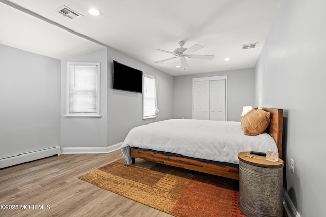 bedroom with wood finished floors, visible vents, baseboards, recessed lighting, and a closet