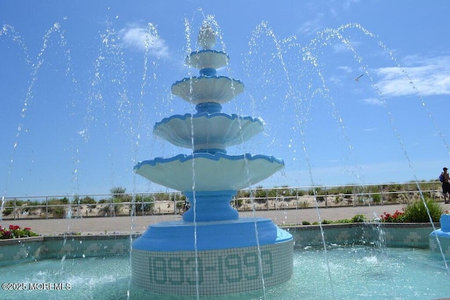 view of swimming pool with a swimming pool and fence