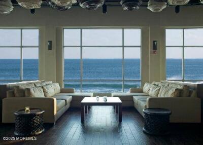 living area with a water view and wood finished floors