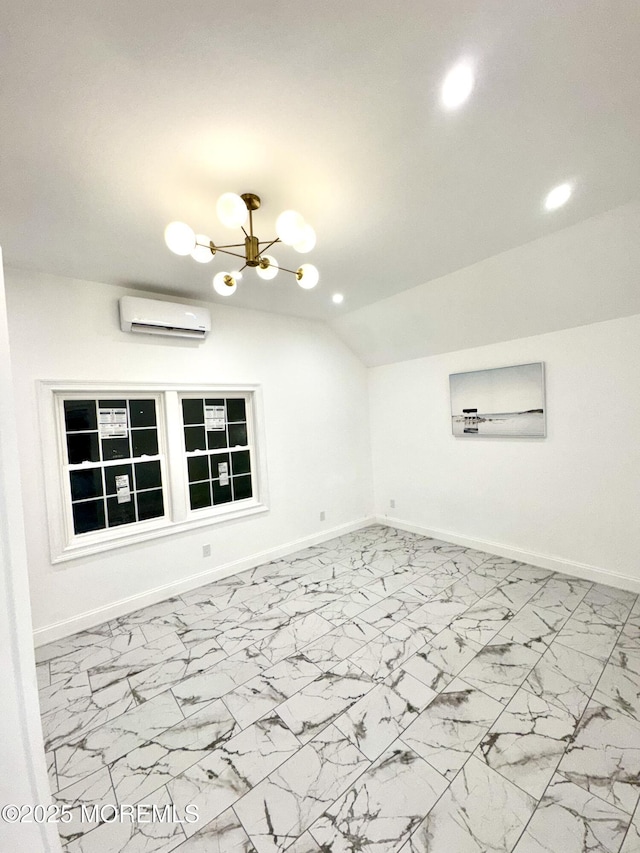 spare room featuring an inviting chandelier, a wall mounted air conditioner, and vaulted ceiling