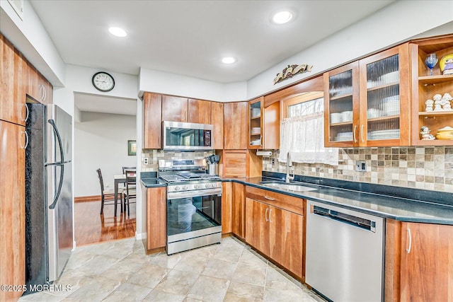 kitchen featuring appliances with stainless steel finishes, sink, and decorative backsplash