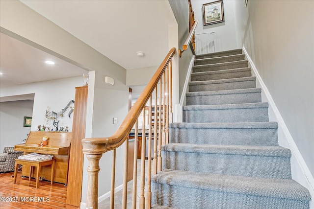 stairway featuring hardwood / wood-style floors