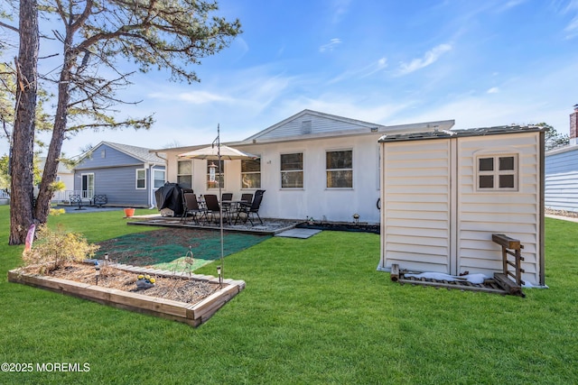 rear view of house with a yard and a patio area