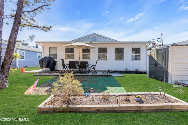 back of property with a shed and a lawn