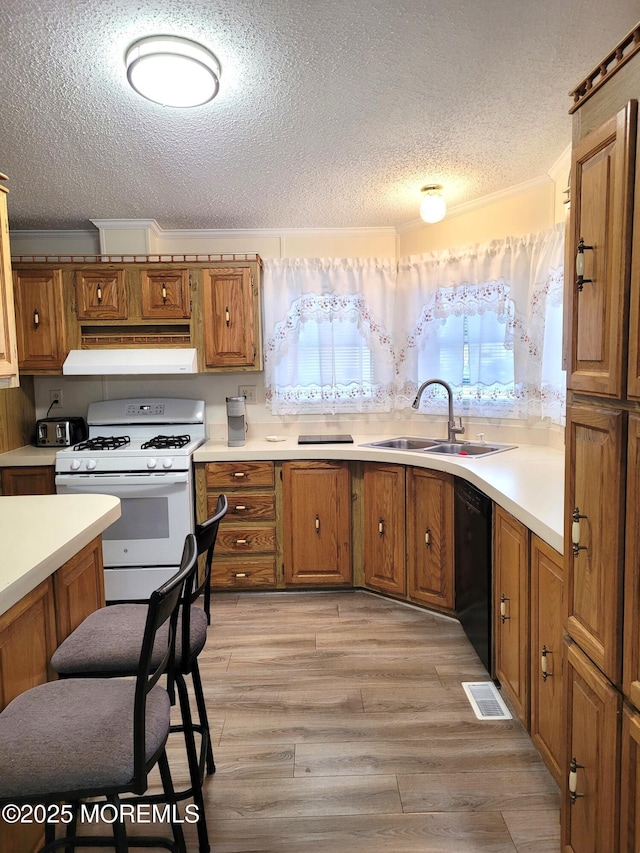 kitchen featuring sink, black dishwasher, white range with gas stovetop, crown molding, and light wood-type flooring