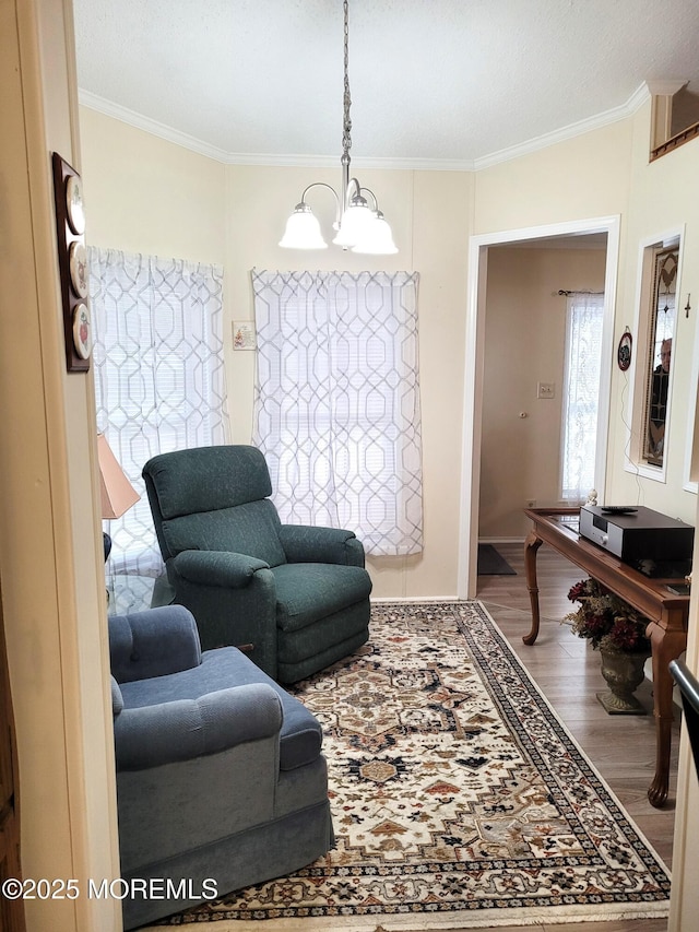 living room with hardwood / wood-style flooring, ornamental molding, and a chandelier