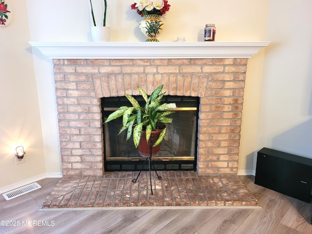 interior details with hardwood / wood-style floors and a fireplace