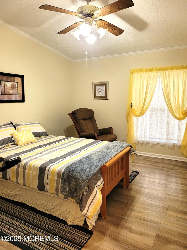 bedroom with crown molding, wood-type flooring, and a textured ceiling