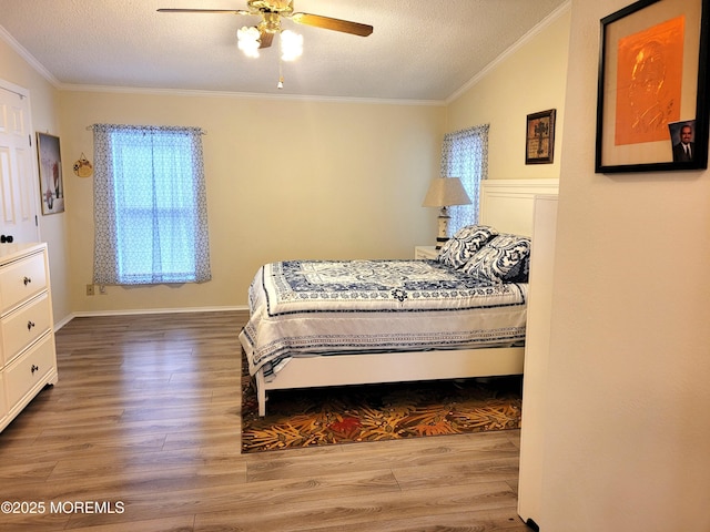 bedroom featuring wood-type flooring, a textured ceiling, and crown molding