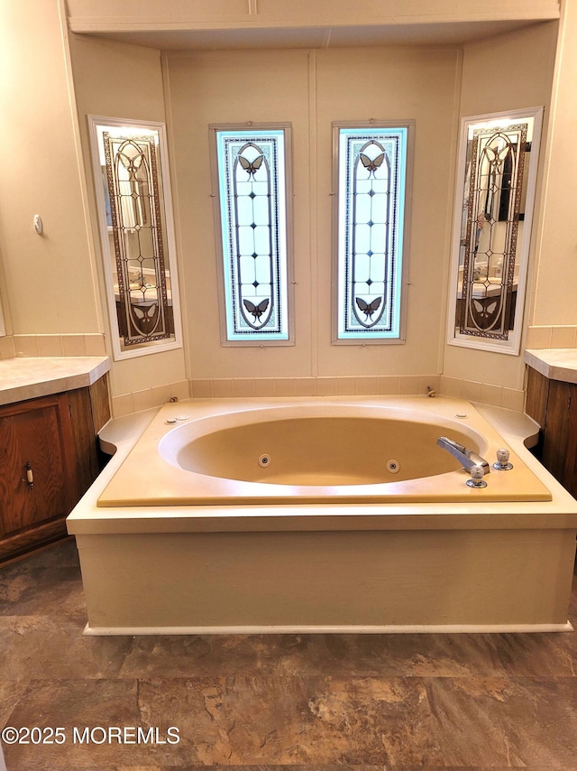 bathroom with vanity and a tub