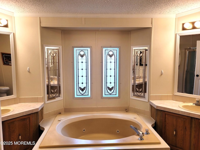 bathroom featuring vanity, independent shower and bath, and a textured ceiling