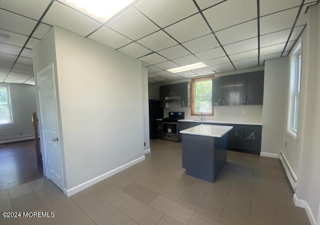 kitchen featuring stainless steel electric stove, sink, a paneled ceiling, and baseboard heating