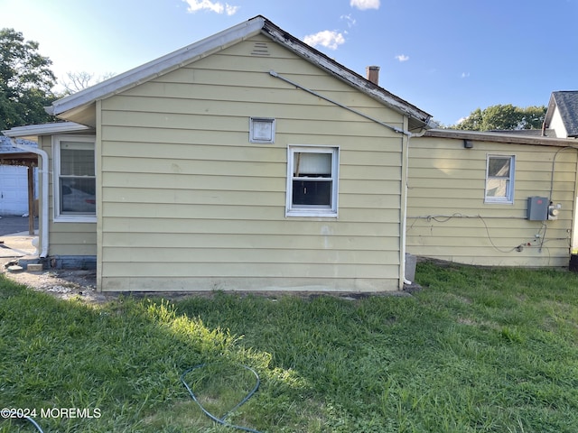 view of side of property with a yard