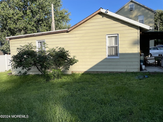 view of side of property with a lawn