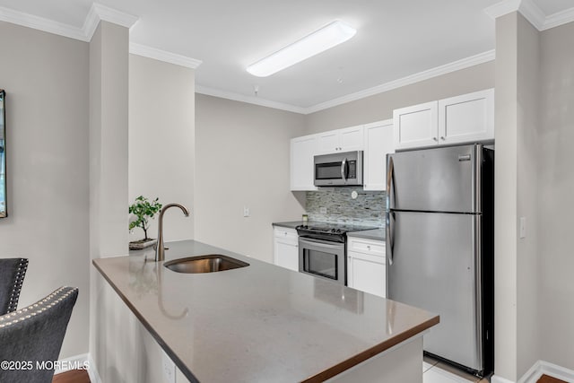 kitchen with sink, appliances with stainless steel finishes, tasteful backsplash, ornamental molding, and white cabinets