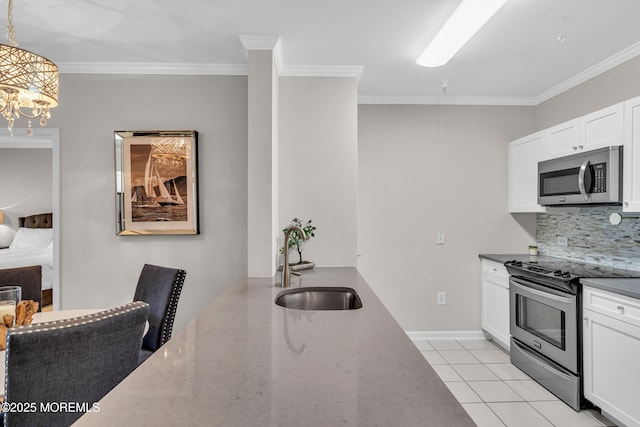 kitchen featuring appliances with stainless steel finishes, sink, white cabinets, hanging light fixtures, and light tile patterned floors