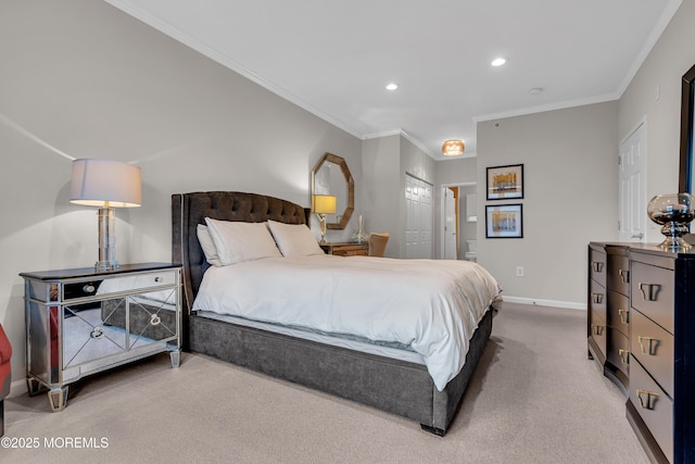 carpeted bedroom featuring crown molding and ensuite bath