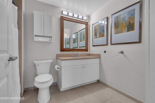 bathroom with tile patterned floors, vanity, and toilet