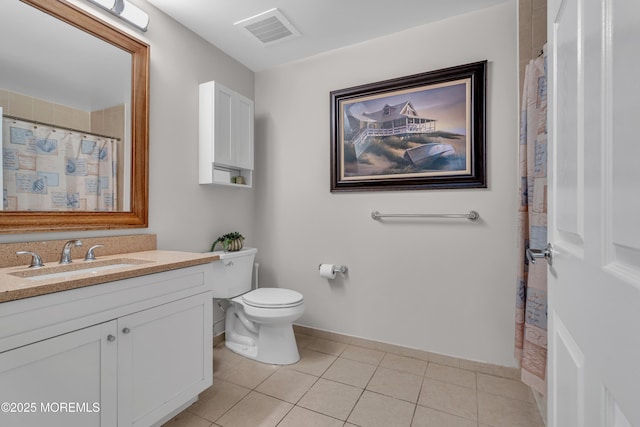 bathroom with tile patterned flooring, vanity, and toilet