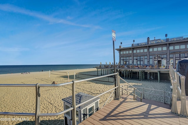 dock area with a view of the beach and a water view