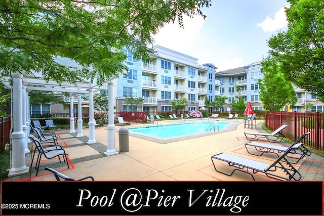 view of pool with a pergola and a patio area