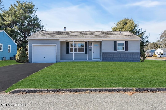 ranch-style house featuring a garage and a front lawn