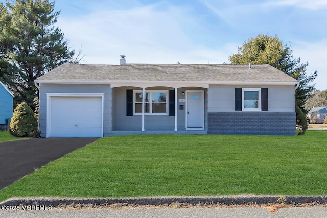 ranch-style house featuring a garage and a front lawn