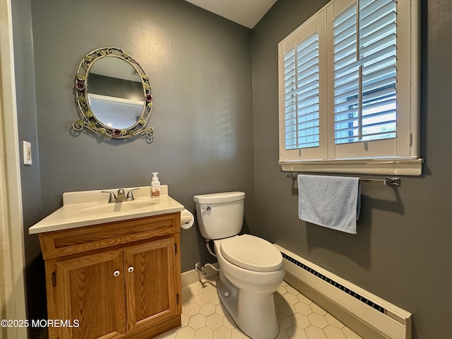 bathroom with a baseboard radiator, vanity, and toilet