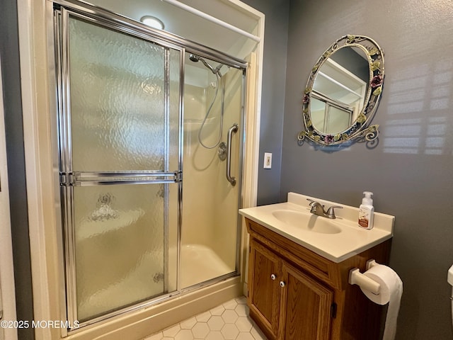 bathroom featuring an enclosed shower, vanity, and toilet