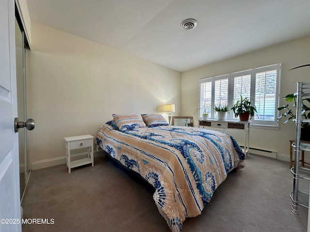 bedroom with a baseboard radiator and dark carpet