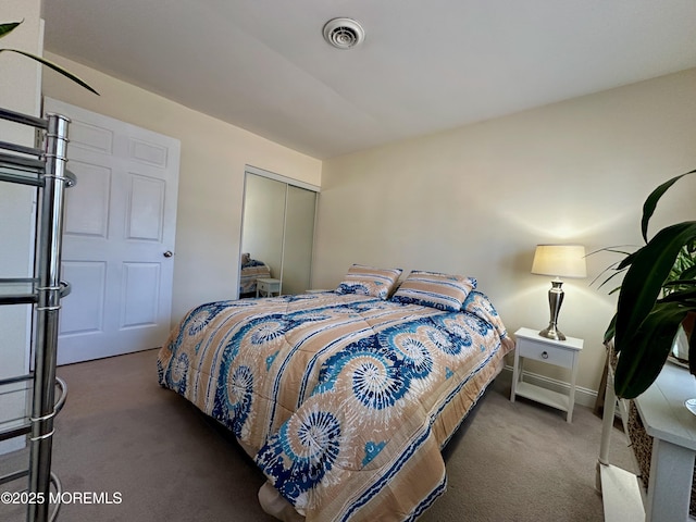 bedroom with a closet and dark colored carpet