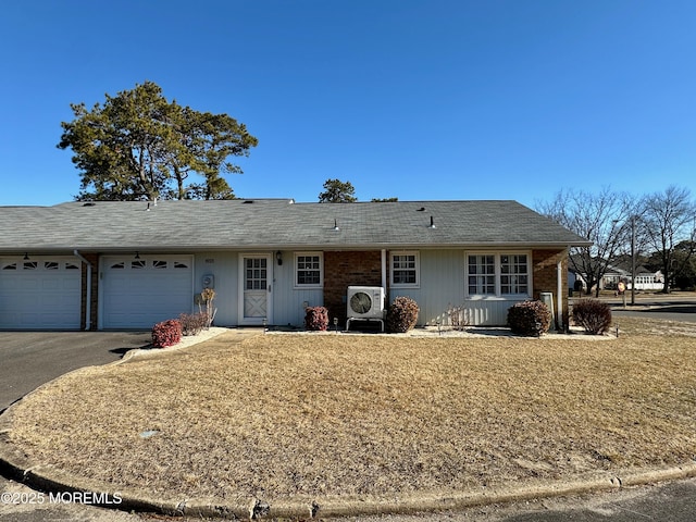 single story home with a garage and ac unit