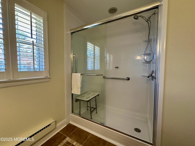 bathroom with an enclosed shower, tile patterned floors, and baseboard heating