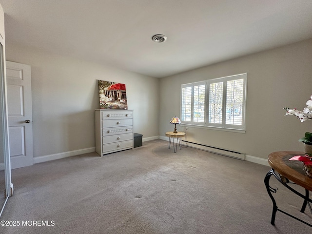 unfurnished room featuring light carpet and a baseboard heating unit