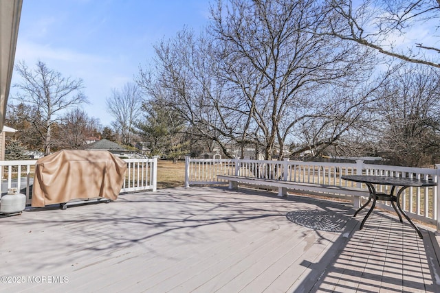 wooden terrace featuring a grill