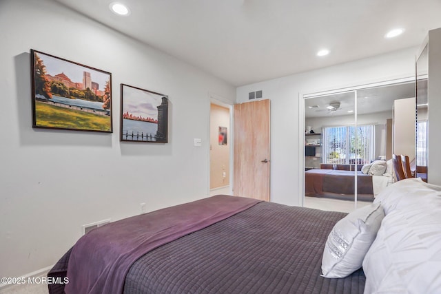 bedroom with a closet, visible vents, and recessed lighting